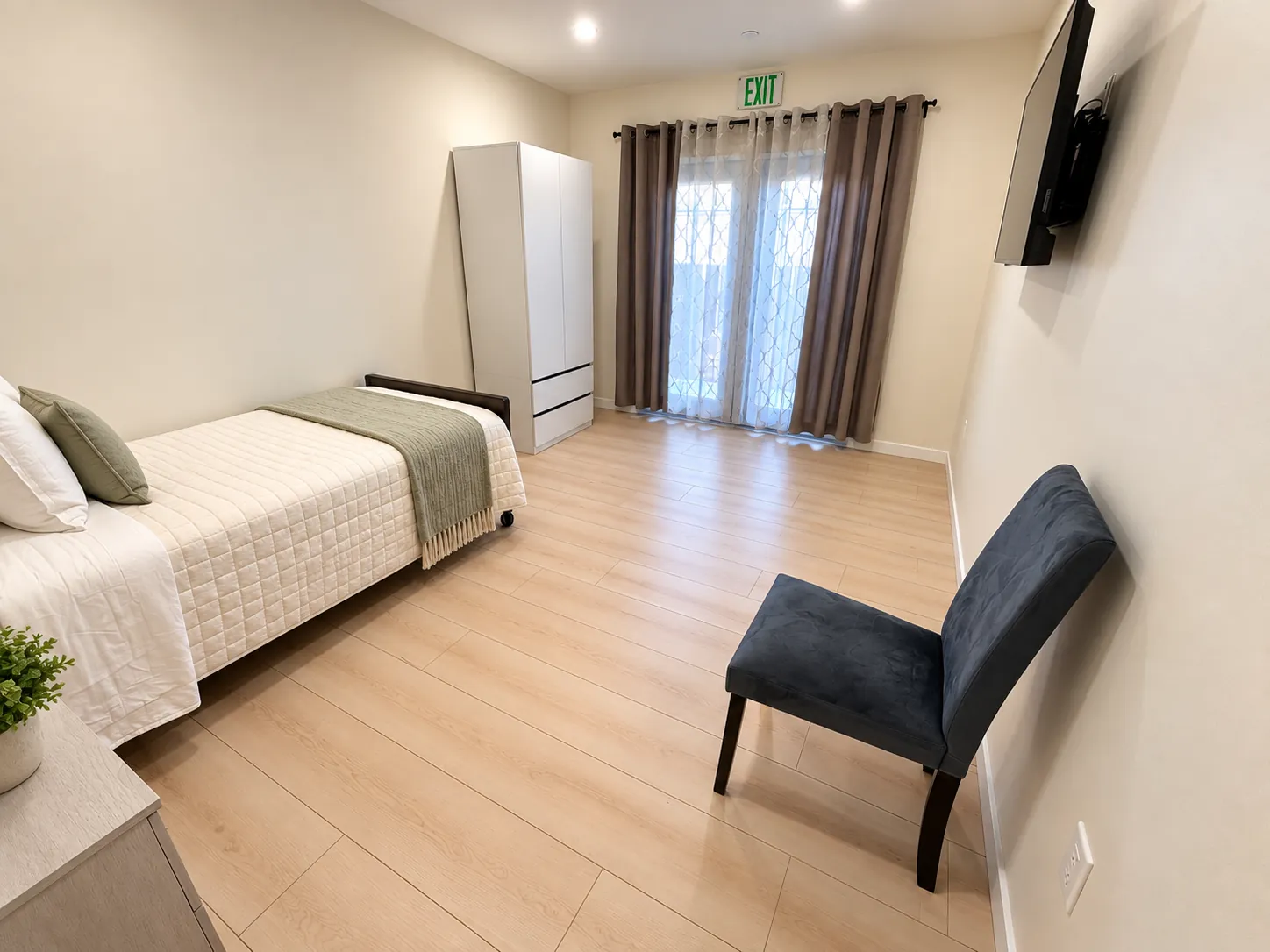 Bedroom with a single bed, armchair, wardrobe and French doors