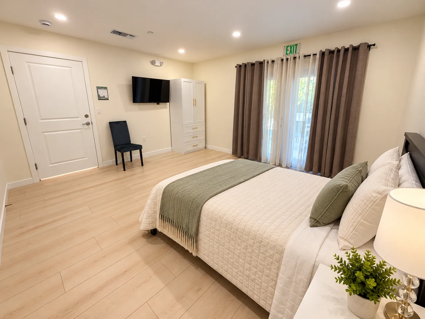 Spacious bedroom with French doors, a wardrobe and wall TV