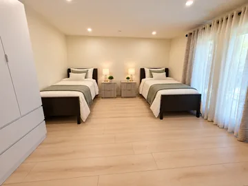 Shared bedroom with two twin beds and matching nightstands