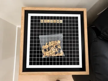 Letter board with tiles spelling WELCOME